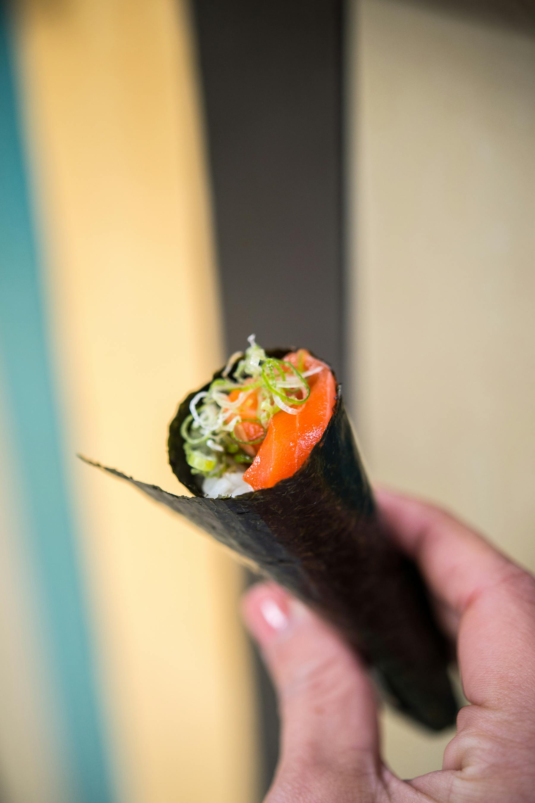 a person holding a piece of food